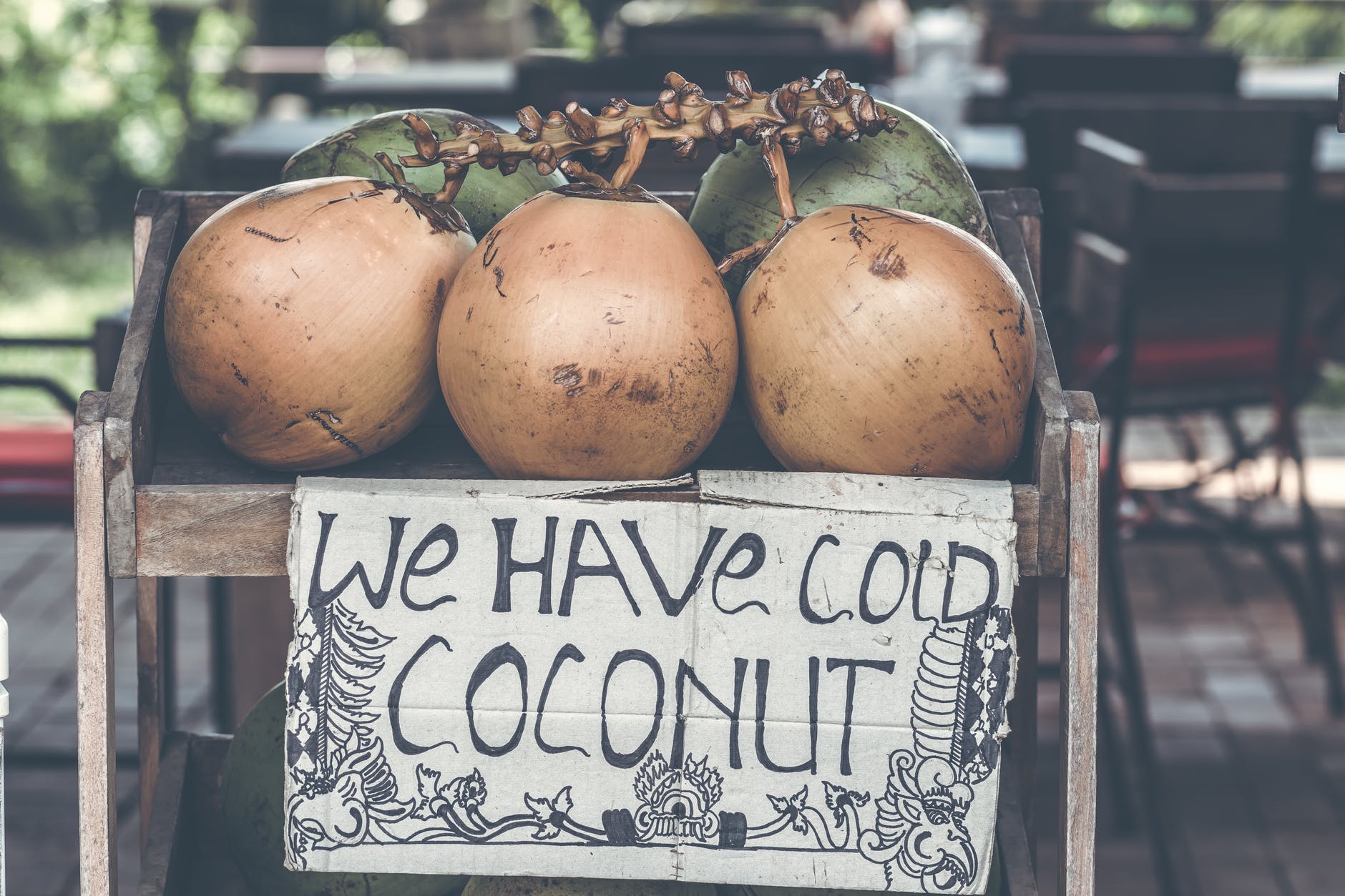 tan coconuts placed atop brown wooden table